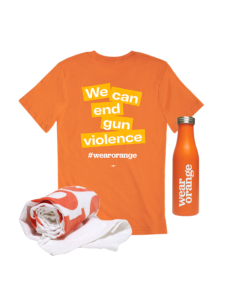 Back view of an orange short-sleeve unisex tee that reads: We can end gun violence #wearorange. A white towel with the Wear Orange logo in orange print. An orange stainless steel water bottle with a white Wear Orange logo.