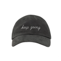 Front view of a gray ballcap with white embroidery that reads KEEP GOING in script font.