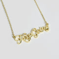 A gold name plate style necklace with the phrase Keep Going in script font.