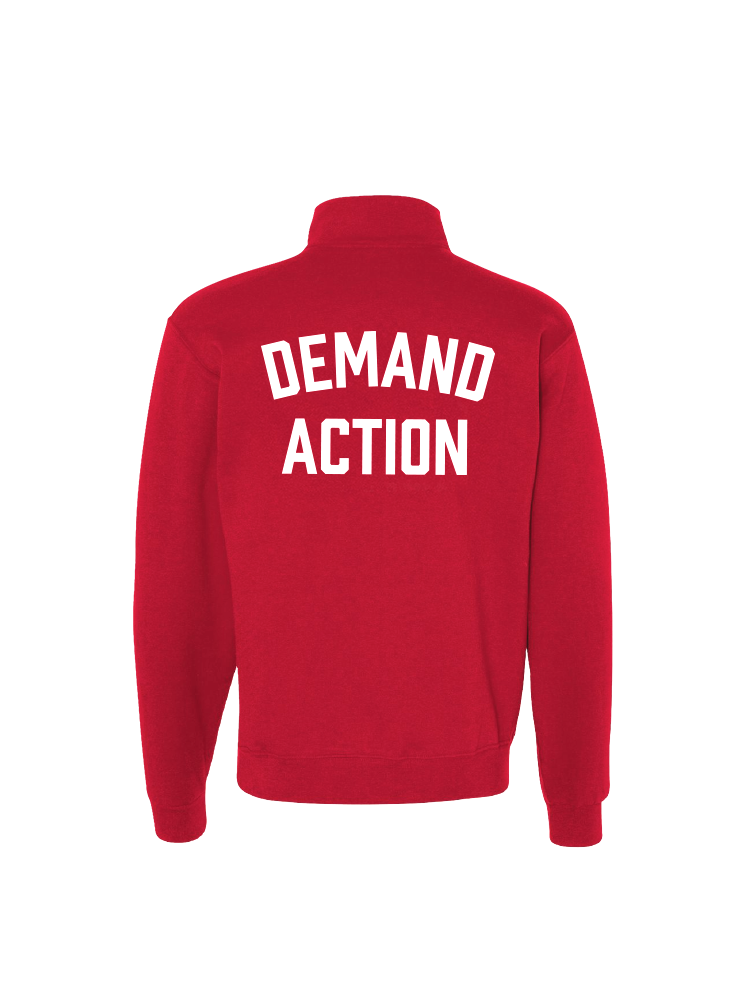 Back view of red quarter-zip collared sweatshirt with the phrase DEMAND ACTION printed in large white all caps text across the back.