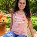 A woman smiles wearing a peach colored women's cut racerback tank top. In an italic, serif font, it reads: Imagine a future free of gun violence. The text is embellished with orange and white flowers, butterflies, and bees. A small Wear Orange logo is printed in orange below the text.